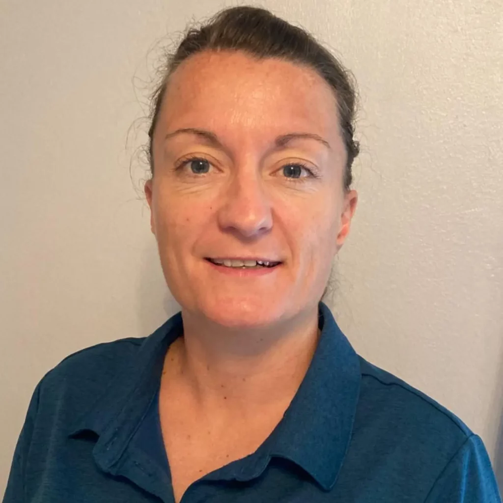 Jo, with hair in pony tail and green collared t shirt on