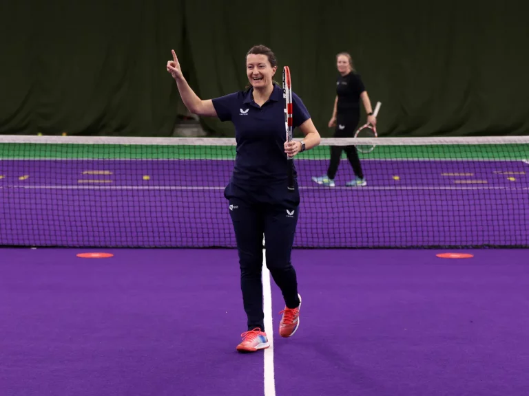 Jo Cunliffe on a tennis court celebrating winning a point